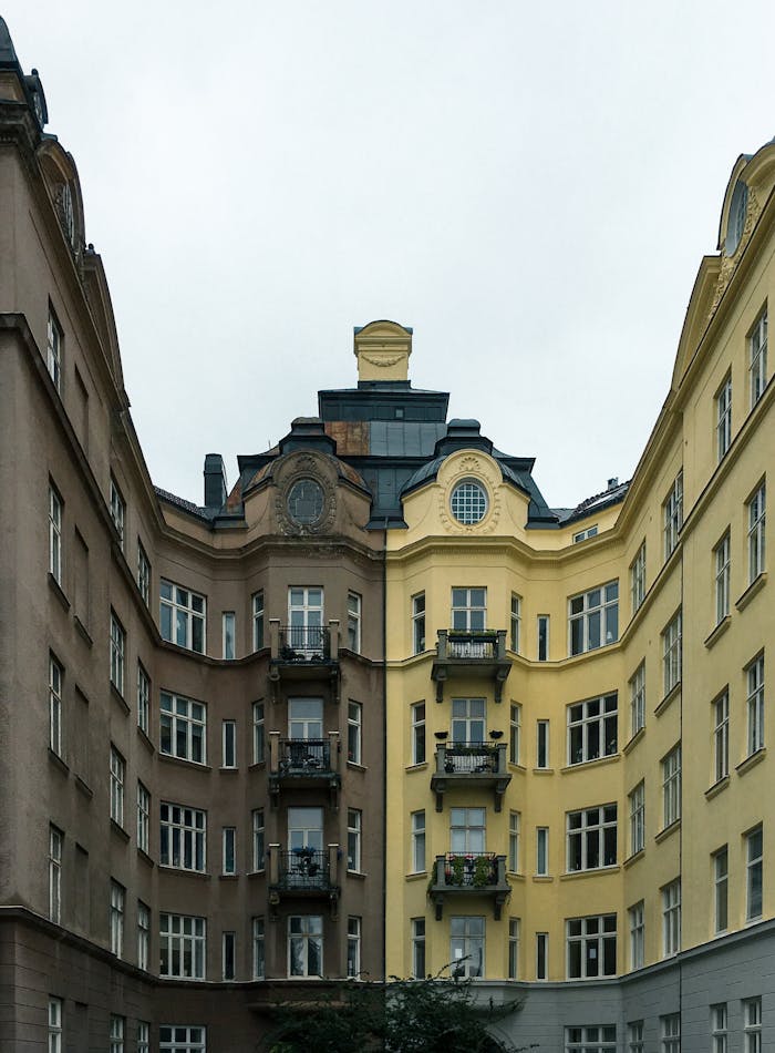 Services Symmetrical view of historic residential buildings with distinctive balconies in Malmö, Sweden.