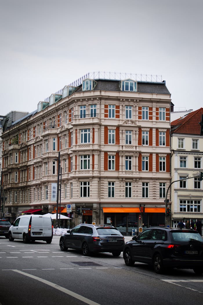 Services Street scene in Hamburg showcasing classic architecture with cars on the road, capturing modern urban life.